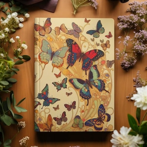 May include: A cream-colored journal with a colorful butterfly design. The cover features a swirling pattern of butterflies in shades of blue, green, red, and yellow.