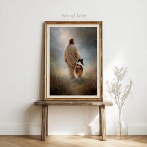 May include: Framed art print featuring a person in a flowing robe walking with a dog through a field. The artwork has a warm color palette with a gold frame. The text "Paw of Love" is in the upper left corner.