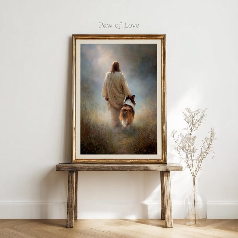 May include: Framed art print featuring a person in a flowing robe walking with a dog through a field. The artwork has a warm color palette with a gold frame. The text "Paw of Love" is in the upper left corner.