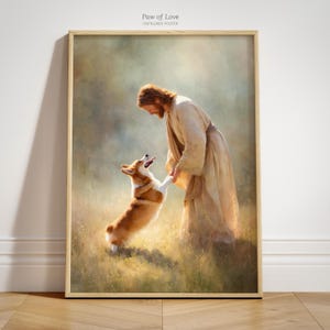 Può includere: Un poster incorniciato intitolato Paw of Love che raffigura una figura con capelli lunghi e barba che indossa una tunica color marrone chiaro, in piedi in un campo erboso mentre tocca le zampe di un cane Corgi marrone e bianco che salta.