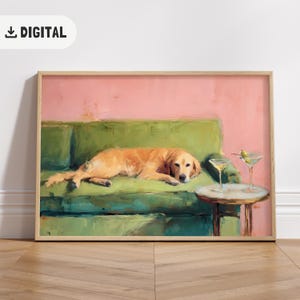 May include: Digital print featuring a golden retriever dog resting on a green sofa, with two martini glasses on a side table. The background is a pink wall. The print is framed in a light wood frame.