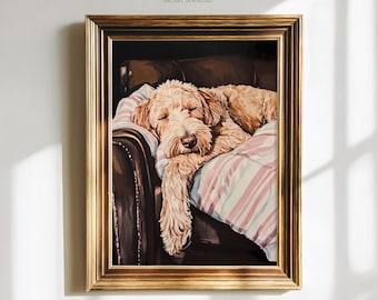 May include: A framed print featuring a sleeping golden doodle dog. The dog is resting on a striped pink and white blanket on a brown leather couch. The frame is gold, and the print has the text "Paw of Love" and "Instant Download".