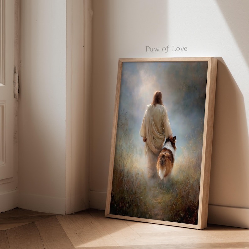 May include: Framed art print featuring a person in a flowing robe walking with a dog. The artwork has a soft, ethereal quality with a light background and the text "Paw of Love". The frame is a light wood color.