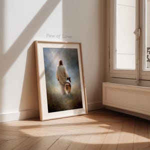 May include: Framed art print featuring a person in a white robe walking with a dog through a field. The artwork has a soft, ethereal quality with a warm color palette. The text "Paw of Love" is visible on the frame.