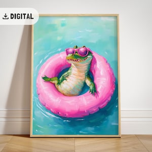 May include: A framed digital print featuring a green alligator wearing pink sunglasses and floating in a pink inflatable ring. The alligator is in a pool of blue water. The print has a wooden frame and the word "DIGITAL" in the upper left corner.