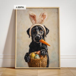 May include: Digital print of a black Labrador wearing bunny ears and holding a carrot. The dog also holds a basket of Easter eggs. The artwork is framed in a light wood frame. The image has a 'DIGITAL' watermark.