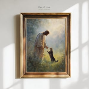 Op de afbeelding: Een ingelijste print met een serene scène van een figuur in witte gewaden die een gestreepte kat aanraakt. Het kunstwerk speelt zich af in een veld van groen en goud, met de tekst "Paw of Love" en "Instant Download" bovenaan.