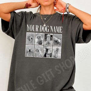 May include: A charcoal grey short-sleeved t-shirt featuring the white text YOUR DOG NAME above a grid of eight black and white photographs of golden retriever dogs in various poses, including sitting, standing, and swimming in water.