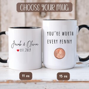 May include: Two white ceramic mugs with black handles and rims. One mug has "Jacob & Olivia EST. 2019" printed on it. The other mug says "YOU'RE WORTH EVERY PENNY" with a penny graphic. The mugs are 11 oz and 15 oz.