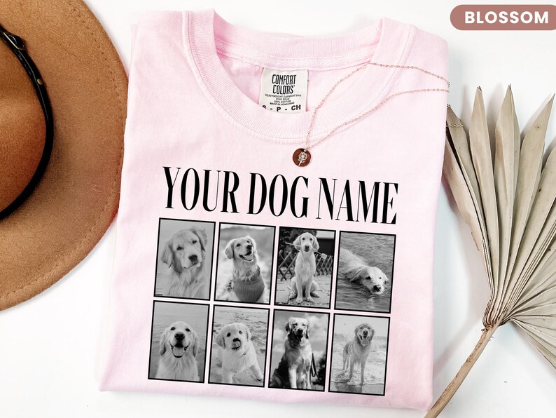 May include: A light pink t-shirt featuring the black text "YOUR DOG NAME" above a grid of eight black and white photographs of golden retriever dogs. The shirt has a crew neckline and a Comfort Colors brand label on the inside collar.