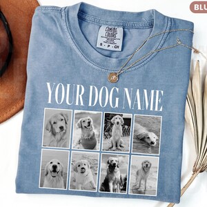 May include: A blue jean coloured t-shirt featuring the text YOUR DOG NAME in white capital letters above a grid of eight black and white photographs of dogs. The shirt has a crew neckline and a Comfort Colors brand label on the inside collar.