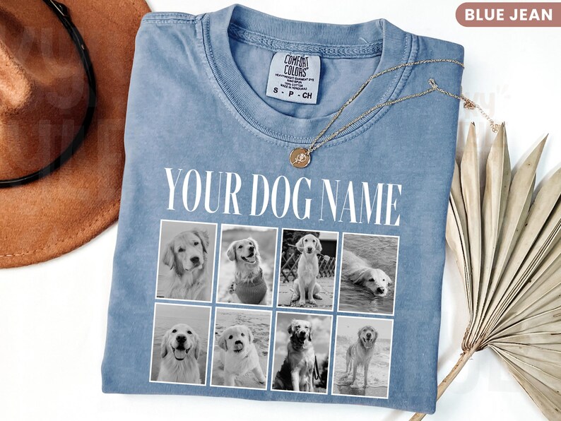 May include: A blue jean coloured t-shirt featuring the text YOUR DOG NAME in white capital letters above a grid of eight black and white photographs of dogs. The shirt has a crew neckline and a Comfort Colors brand label on the inside collar.