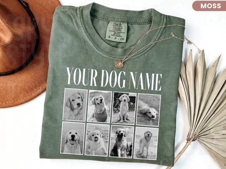 May include: A moss green t-shirt featuring the white text "YOUR DOG NAME" above a grid of eight black and white photographs of dogs. The shirt has a crew neckline and a Comfort Colors brand label on the inside collar.