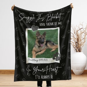 May include: Black blanket with a photo of a German Shepherd dog, paw prints, and text. The text reads "Snuggle This Blanket And Think Of Me" and "In Your Heart I'll Always Be". The dog's name and years are also printed on the blanket.
