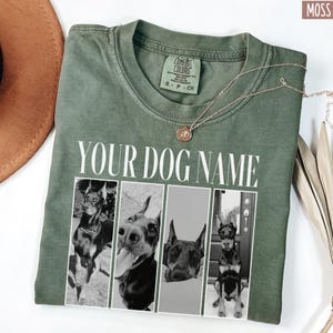 May include: A green t-shirt with a white text overlay that says "YOUR DOG NAME". The shirt features four black and white photos of dogs in a collage format.