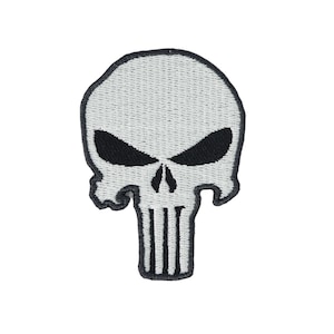 May include: White embroidered skull patch with black eyes and a black skull outline. The skull has a black and white striped design on the bottom.