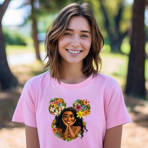 a woman wearing a pink shirt with a disney character on it