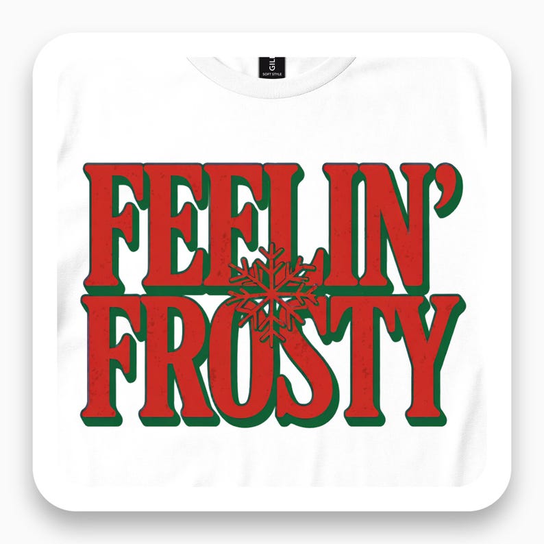 White tee close-up with red and green Feelin' Frosty text and snowflake.