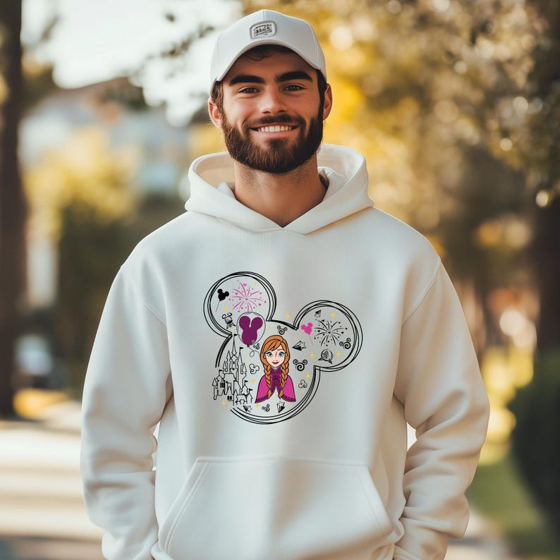 a man wearing a white hoodie with a cartoon character on it
