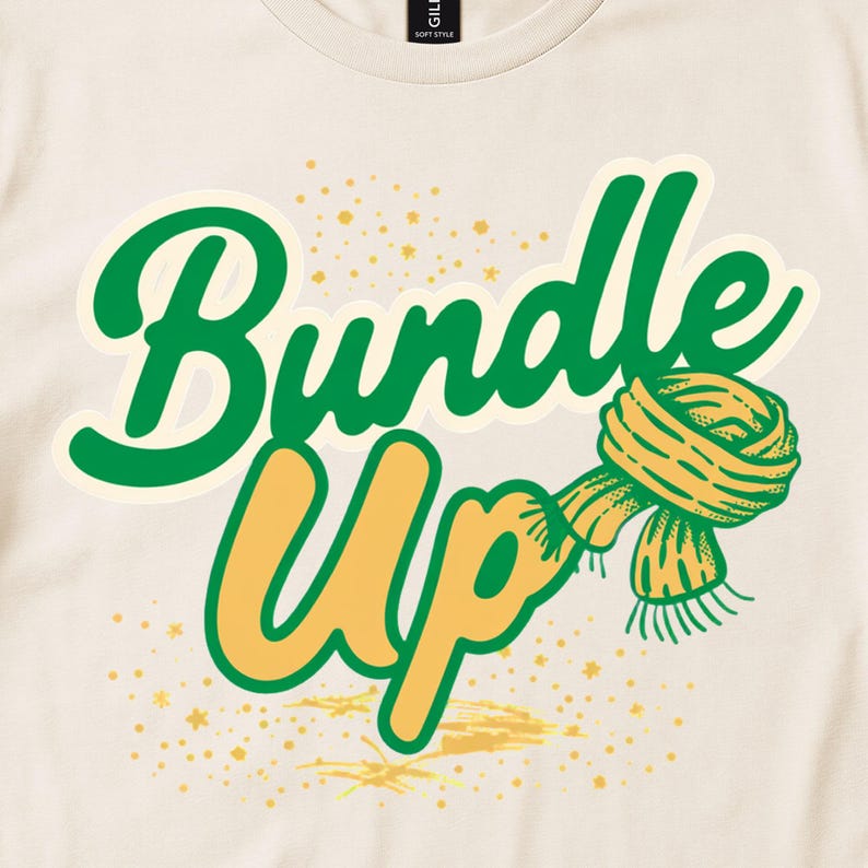 Cream tee detail with green and yellow Bundle Up lettering and a striped scarf.