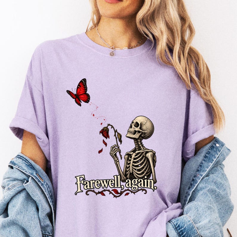 Model in lavender tee with skeleton, wilted flower and red butterfly.