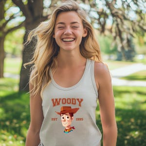 a woman wearing a woody shirt and a cowboy hat