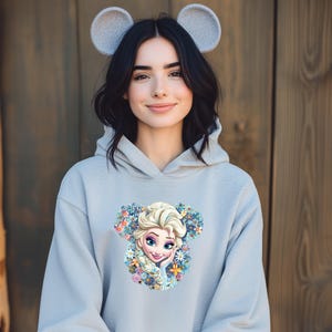 a woman wearing a hoodie with ears on her head