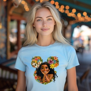 a woman wearing a blue shirt with a picture of a disney character on it