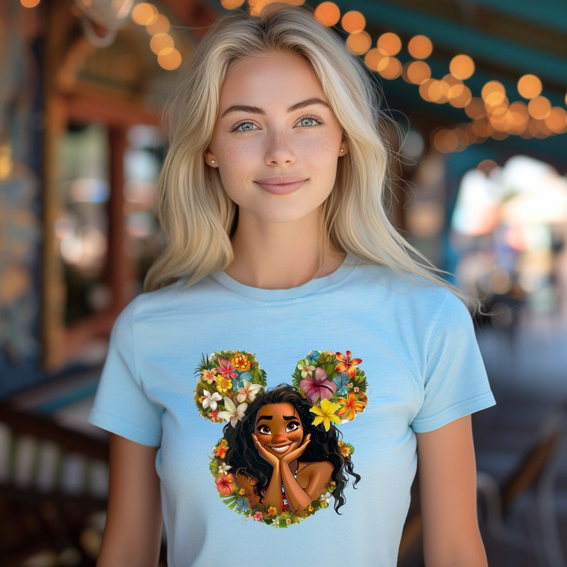 a woman wearing a blue shirt with a picture of a disney character on it