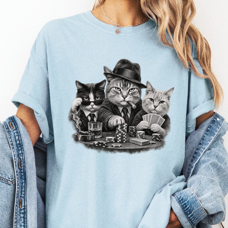 Pale blue tee detail with three grayscale cats playing cards, including a cat in a fedora.