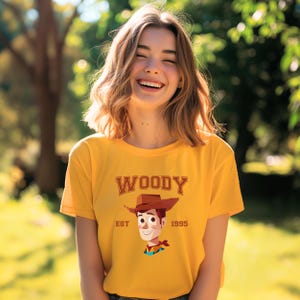 a woman wearing a woody t - shirt and smiling