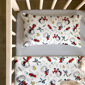 May include: A white ceramic mug with a black handle and the text "But First, Coffee" in a handwritten style. The mug is on a white surface. The mug is approximately 4 inches tall.