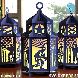 May include: Navy blue paper lanterns with cut-out designs of American flags, stars, and soldiers. The lanterns have a hexagonal shape and a loop at the top. The words "DIGITAL DOWNLOAD" and "SVG DXF PDF EPS CDR" are at the bottom.