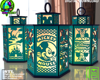 May include: Three teal lanterns with black accents, featuring Mickey Mouse designs and cut-out silhouettes. The lanterns have a handle on top and are illuminated from within. The image also includes the text "DIGITAL DOWNLOAD" and "STL".