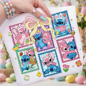 May include: White t-shirt with a colourful graphic of Stitch and Angel in Easter-themed postage stamp designs. The design includes pastel colours, Easter eggs, and a large pink bow.