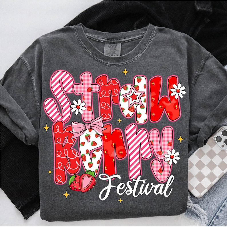 May include: A gray t-shirt with a red and pink graphic that says "Strawberry Festival" with strawberries and flowers.