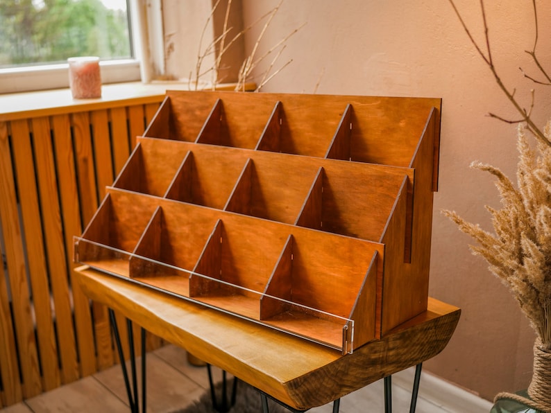 May include: A wooden display stand with multiple shelves, perfect for showcasing small items. The stand is made of natural wood and has a rustic, farmhouse style.