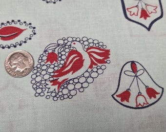May include: A light-colored fabric featuring a repeating pattern of red and dark blue printed motifs, including a bird surrounded by circles, floral shapes, and leaves. A silver-colored United States dime is placed on the fabric for scale.