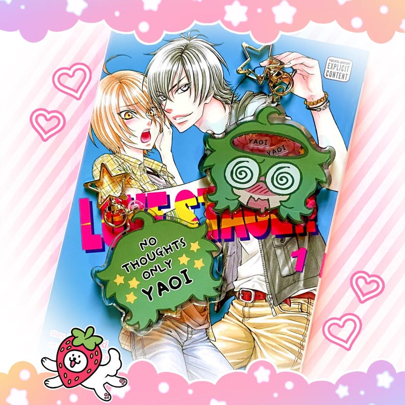 May include: A colorful anime-style illustration featuring two characters and a green charm with the text "NO THOUGHTS ONLY YAOI". The image has a manga-style cover with the word "LOVE" and the number "1". The charm has the word "YAOI" on it.