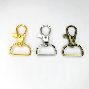 May include: Three metal swivel clasps in gold, silver, and bronze.