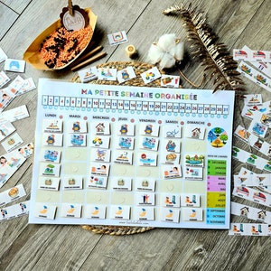 Puede incluir: Un planificador semanal colorido con un diseño de cuadrícula para cada día de la semana. El planificador incluye una sección para el mes del año y una sección para actividades. El planificador se titula "Ma Petite Semaine Organisée".