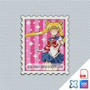 May include: A cross-stitch pattern shaped like a postage stamp featuring a blonde character with yellow hair, a red and white top, and a blue skirt against a pink background with white sparkles. The text @LUNARFOXSTITCH is printed at the bottom.
