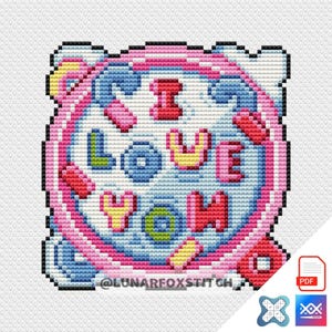May include: A cross-stitch design in a circular shape with the words "I LOVE YOU" in various colors. The design features pink, blue, yellow, and red accents, with the text and border outlined in black. The text "@LUNARFOXSTITCH" is at the bottom.