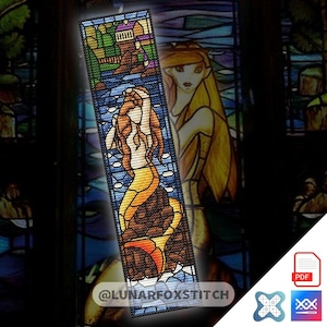 May include: A rectangular cross-stitch pattern featuring a mermaid with long hair sitting on a rock, set against a stained-glass style background with a house and landscape. The design includes the text LUNARFOXSTITCH at the bottom.