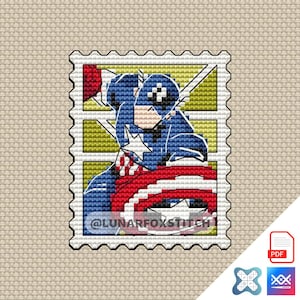 May include: A cross-stitch pattern featuring Captain America in a stamp design. The image shows Captain America in his blue, white, and red costume, holding his shield. The background is yellow with white lightning bolts. The text "@LUNARFOXSTITCH" is visible.
