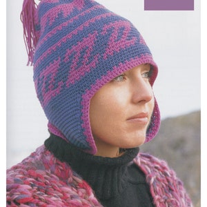 May include: A purple and blue crocheted hat with a long tassel. The hat has ear flaps and a geometric pattern.