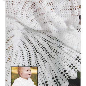 May include: White crochet shawl and jacket. The shawl has a scalloped edge and a detailed openwork pattern. The jacket is shown on a baby and has a V-neck design. The text in the image reads: "4 Ply / Fingering Weight Yarn Crochet Shawl & Knitted Jacket."