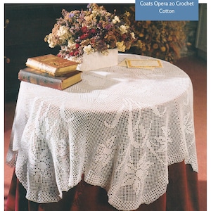 May include: White crochet tablecloth with a delicate floral pattern. The tablecloth is 146cm in diameter and made with Coats Opera 20 crochet cotton.