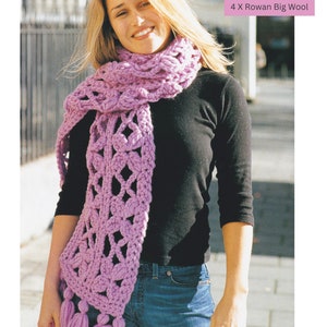 May include: A purple crocheted scarf with tassels. The scarf is made with super chunky yarn and is 4 x Rowan Big Wool. The text "Super Chunky / Super Bulky Yarn CROCHET 4 X Rowan Big Wool" is printed on a pink background.