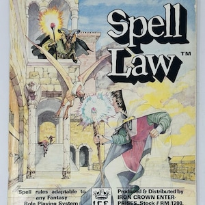 May include: A vintage "Spell Law" role-playing game book cover. The cover art shows a fantasy scene with a wizard, a dragon-like creature, and a castle. The title is in bold, black letters. The text reads "Spell rules adaptable to any Fantasy Role Playing System."
